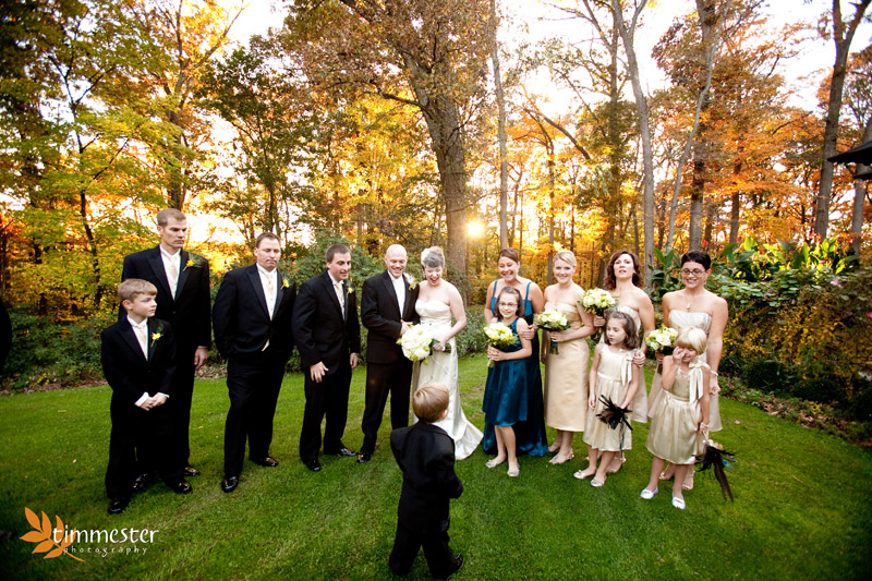 The adults try to convince the ringbearer he wants to be in the picture.  Love this :)