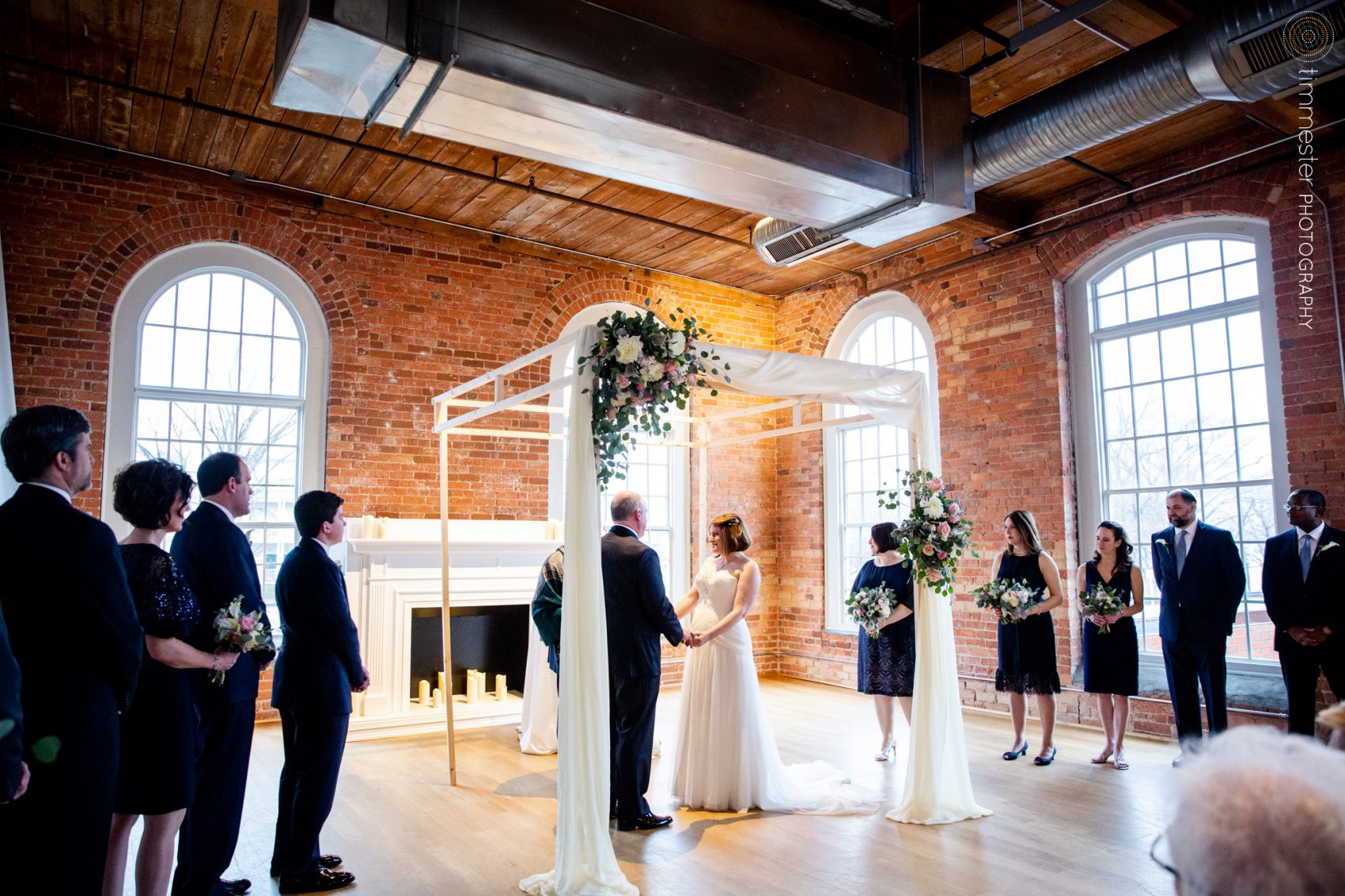The Cotton Room in Durham, NC features an amazing ceremony space for winter weddings like Jessica + David's.