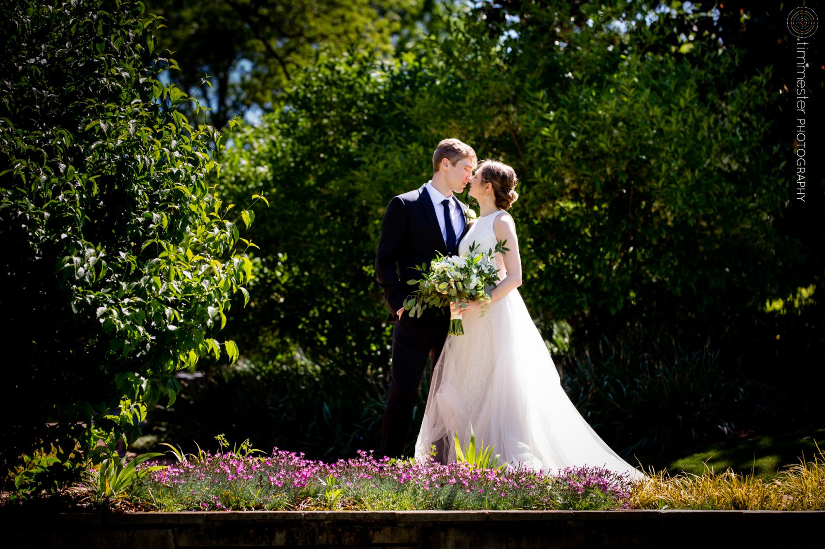 An outdoor garden ceremony in Raleigh with portraits of the bride and groom at Fred Fletcher Park.