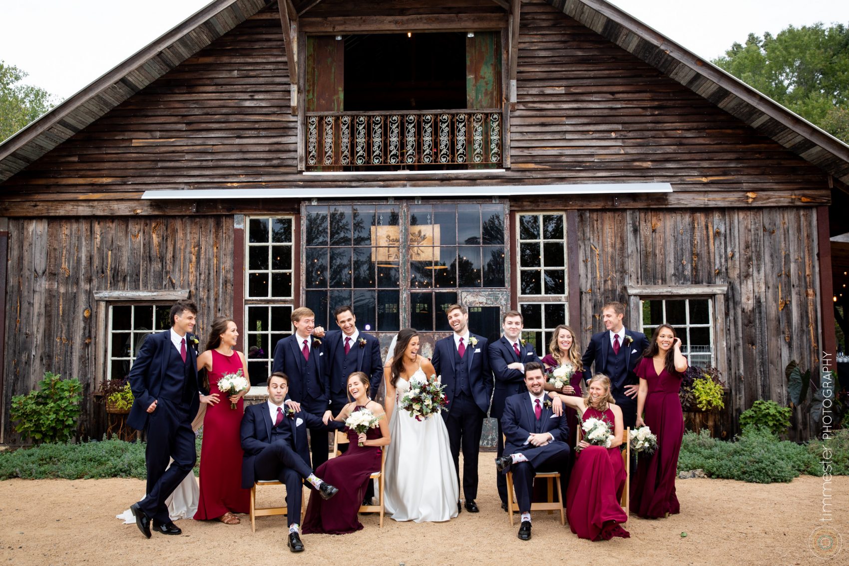 A wedding part poses in front of the Sassafras Fork Farm in Rougemont, NC.