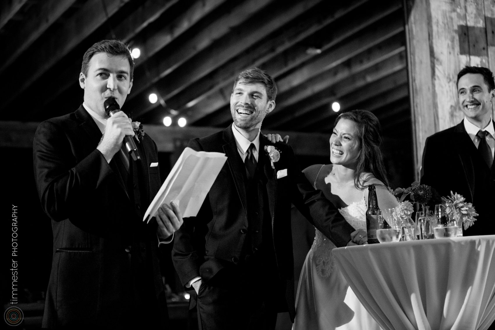 Toasts and wedding reception in the barn of Sassafras Fork Farm in NC.
