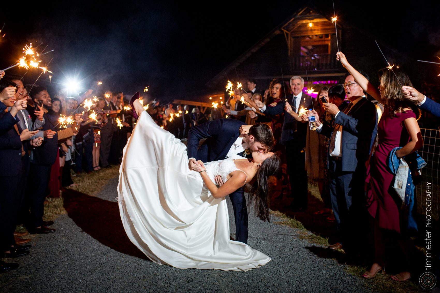 A bride and groom's wedding day and sparkler exit at Sassafras Fork Farm in Rougemont, NC.