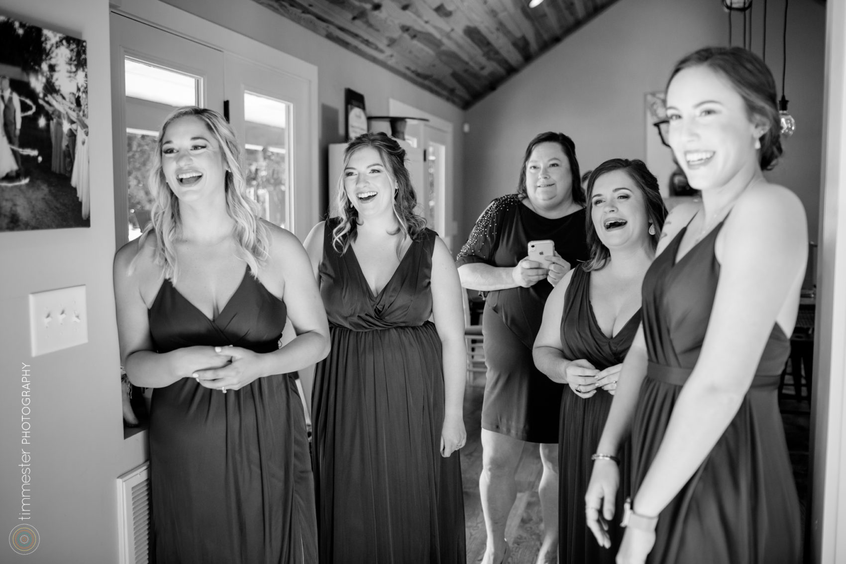 The bridesmaids react to the bride's gown at Sugarneck wedding venue