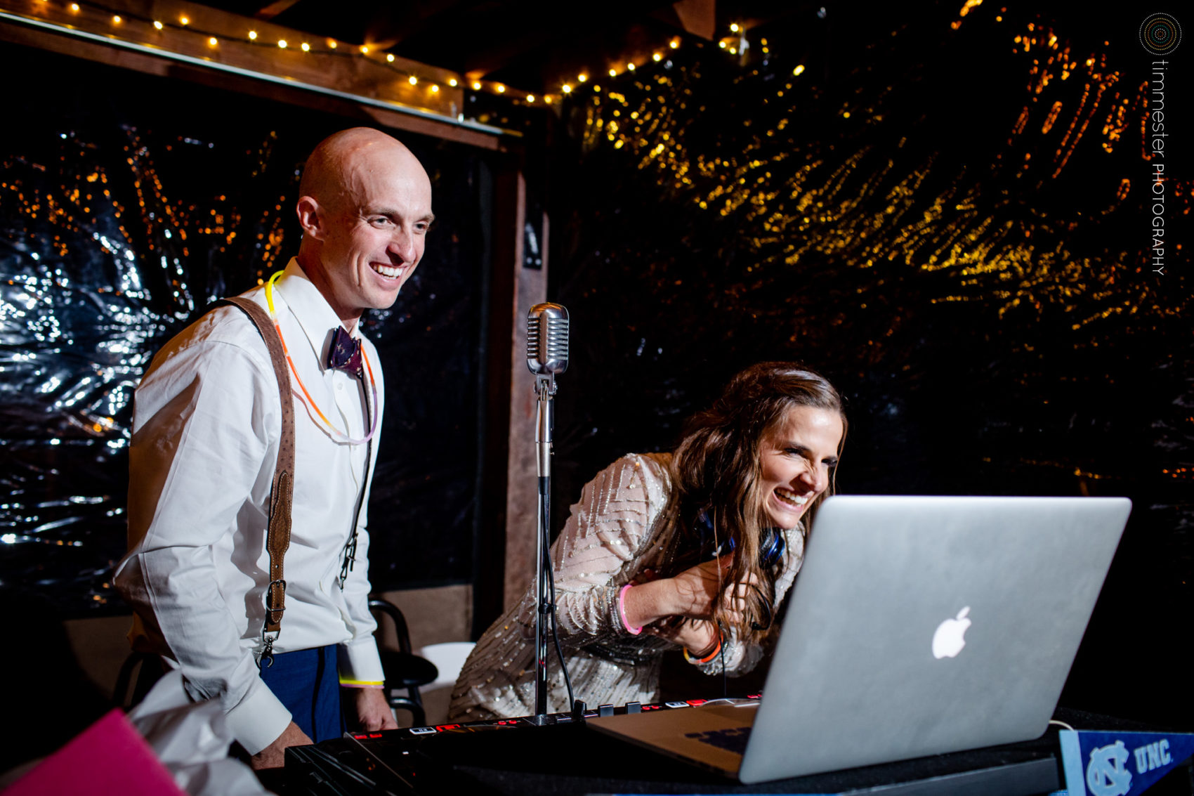 The bride and groom DJ at their wedding reception at Chapel Hill Carriage House