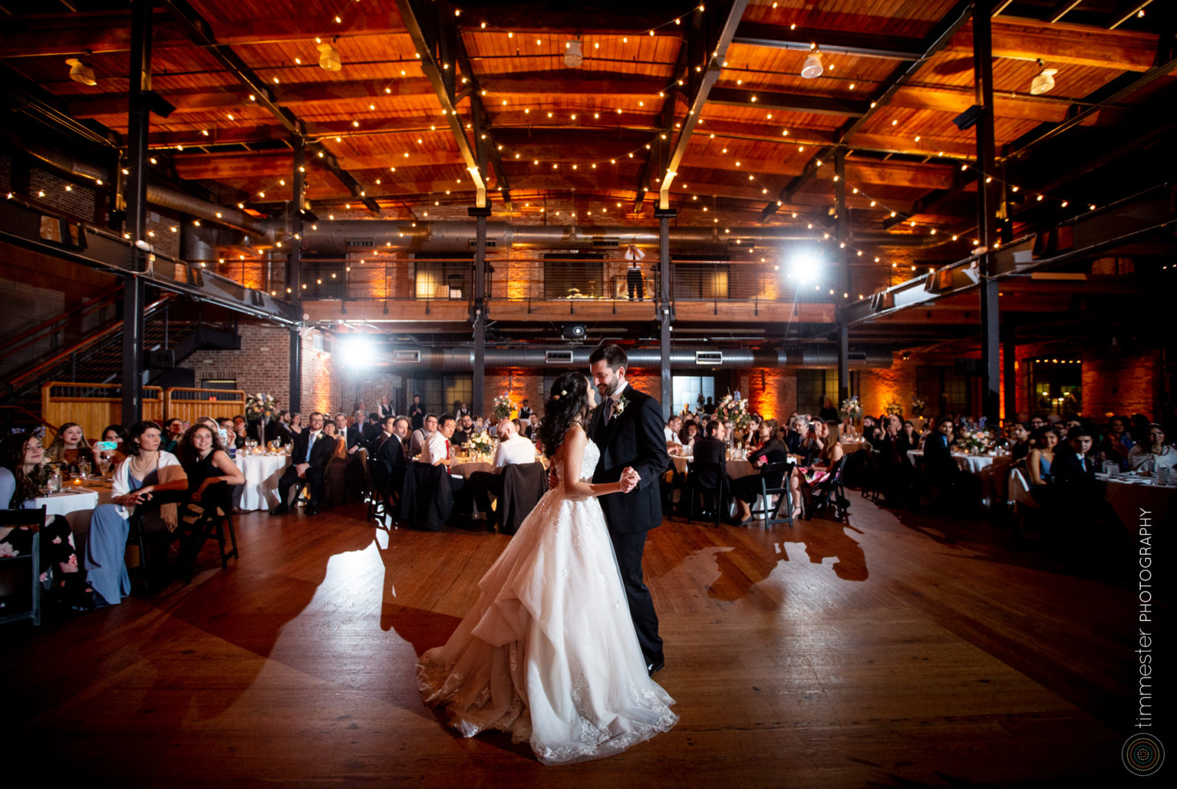 The bride and groom's first dance and reception at Bay 7 in Durham, NC