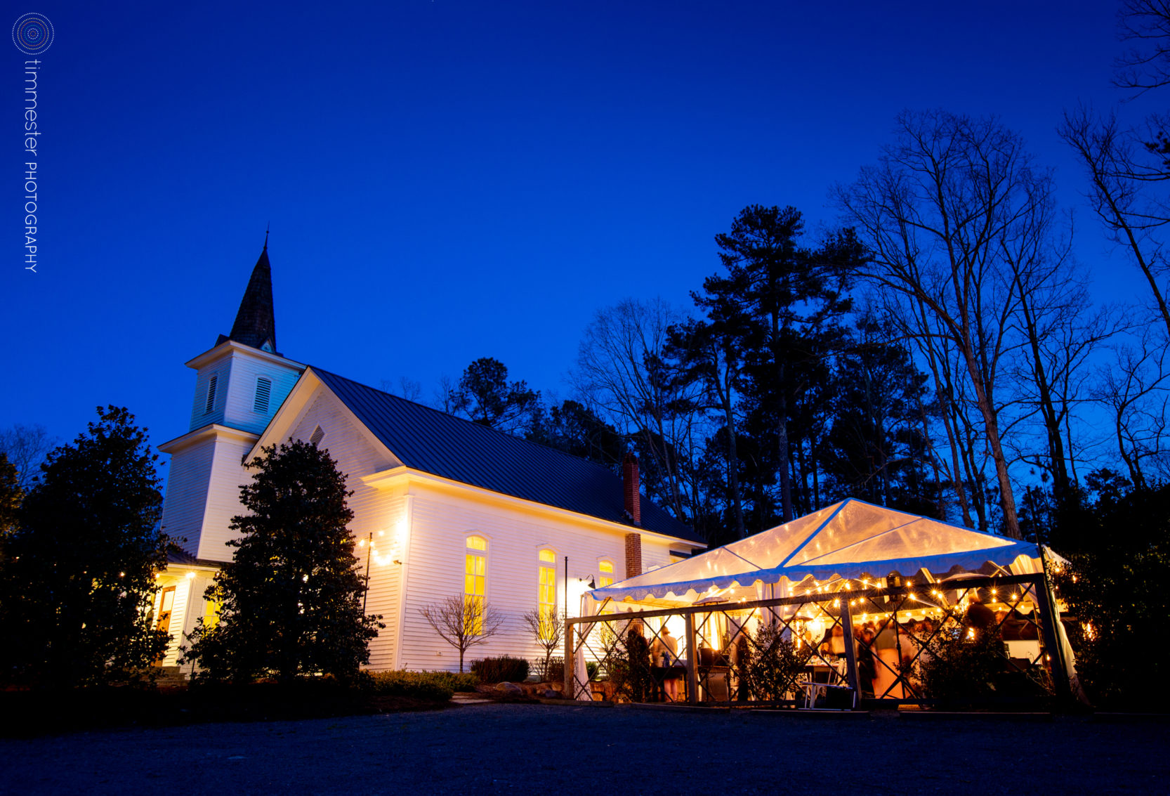 An outdoor, tented evening wedding reception at The Parlour at Mann's Chapel in Chapel Hill, NC