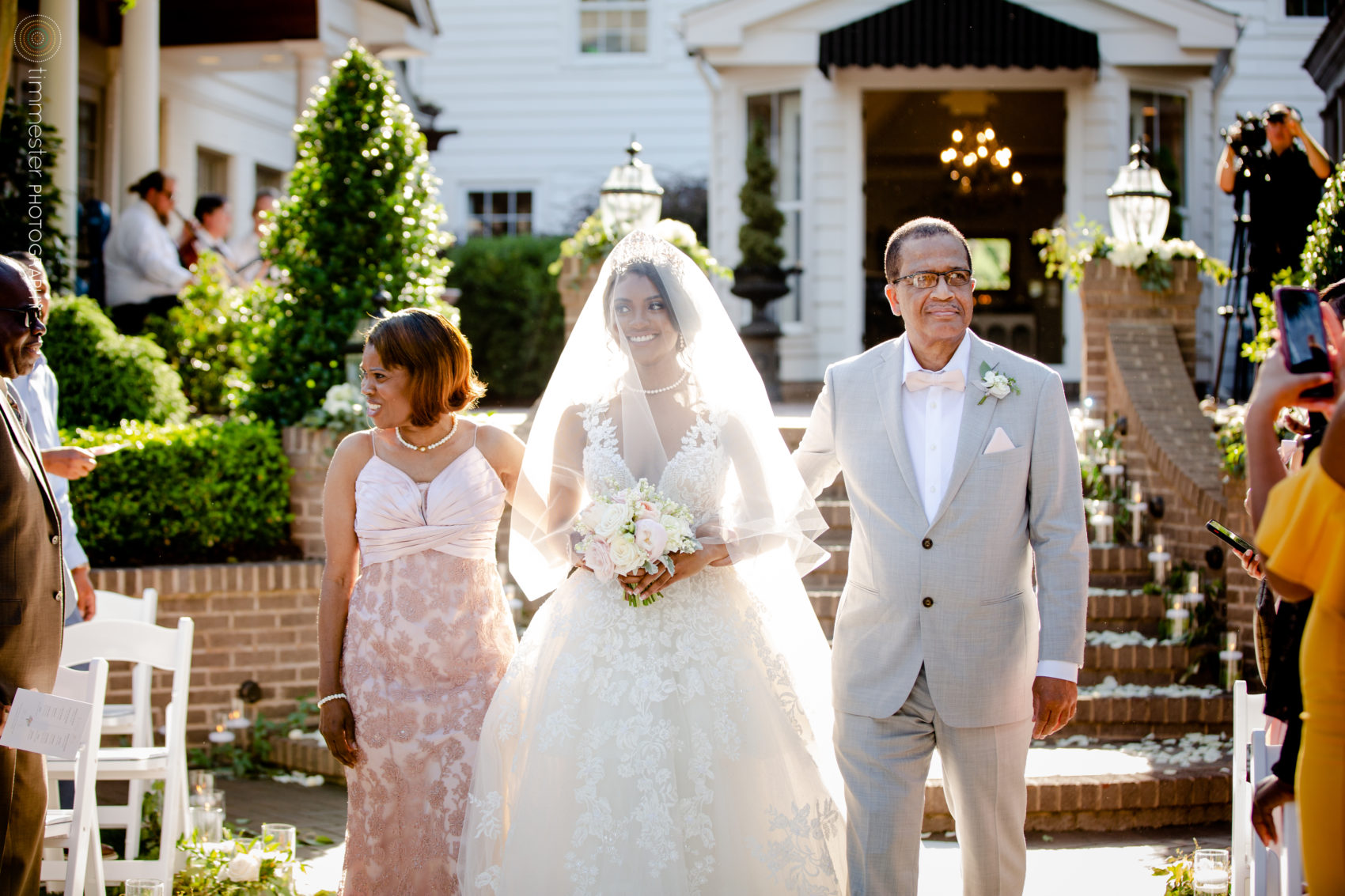 An outdoor wedding ceremony and bride's processional at Highgrove Estate.