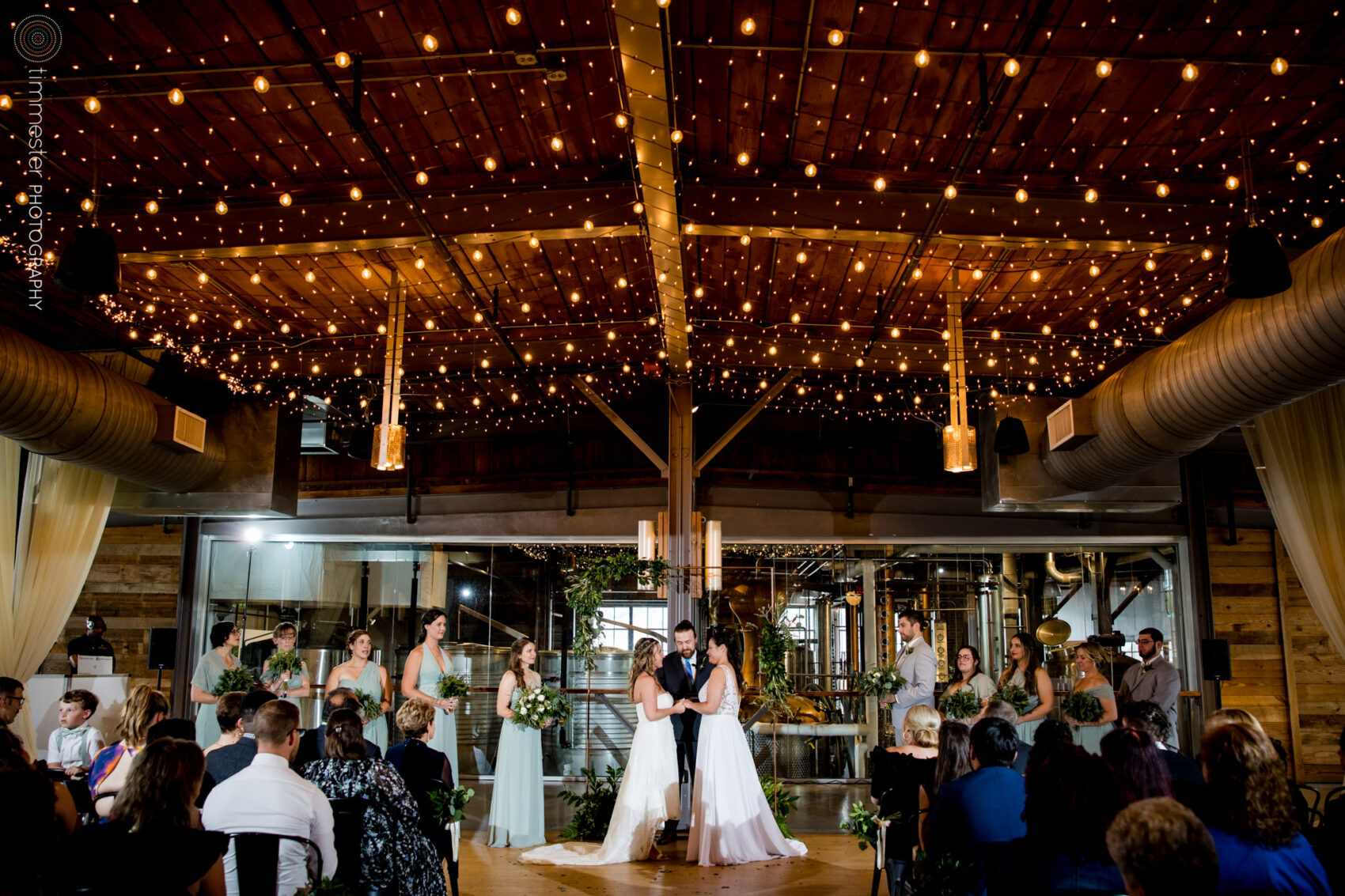 An indoor, rainy day ceremony at The Rickhouse in Durham, NC