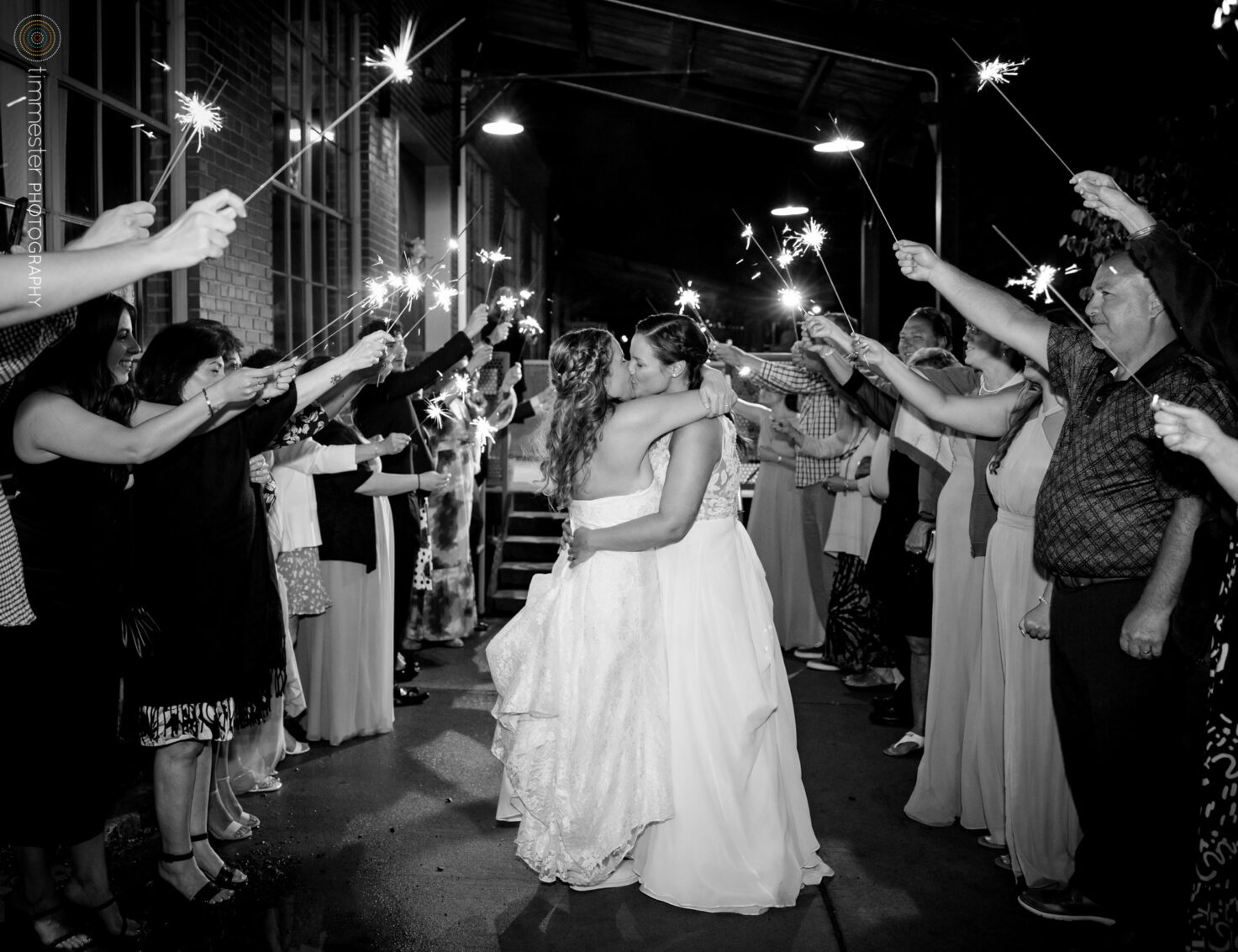 A wedding sparkler exit with two brides at The Rickhouse in Durham, NC